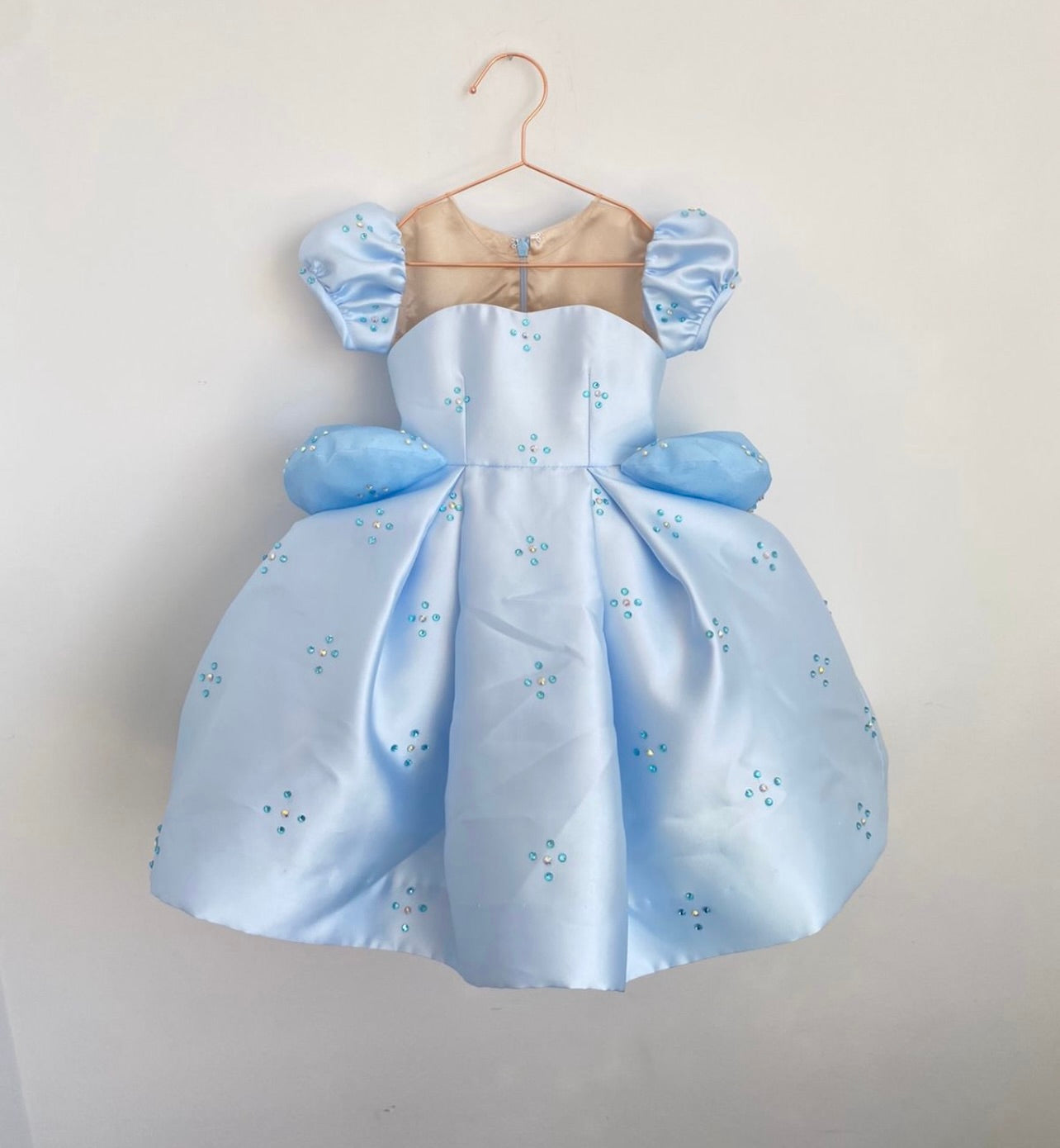 Cinderella Dress-Up Costume in beautiful satin blue, adorned with hand-placed Swarovski crystals. Features stretchy power mesh in three skin tone options, pillowy peplum poofs, and a convenient back zip with keyhole closure.