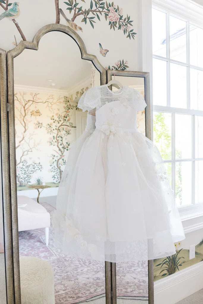 Communion and Baptism dress Isla Rose.
Elegant custom-made white Communion and Baptism dress, featuring intricate lace details and floral embellishments.
