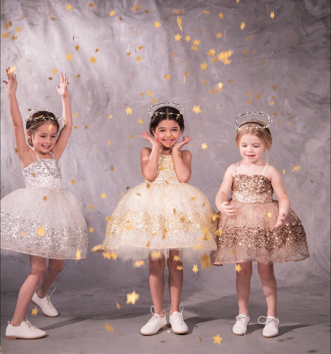 Three sparkly dresses with glittery paillettes and woven metallic threads, featuring a plush petticoat and adjustable grosgrain ribbon straps for birthday celebrations and black tie weddings
