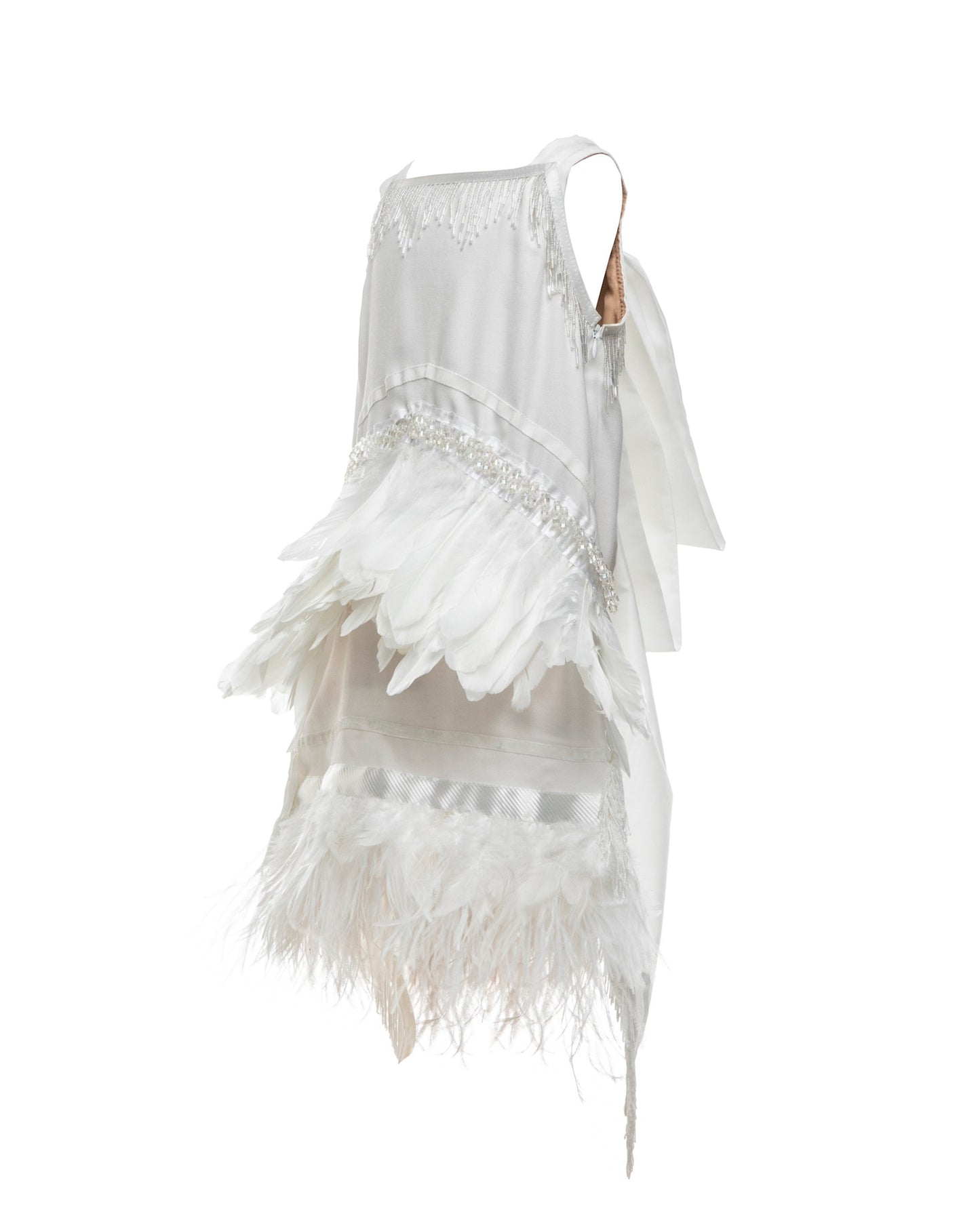 The Imogen, an art deco-inspired A-line dress featuring beaded fringe, silk, velvet, and a playful layer of ostrich feathers. Designed for movement and elegance, complete with an oversized satin bow. Fully lined with a silky soft finish and a side zip closure. Handcrafted in Brooklyn with optional personalized embroidery. Perfect for weddings, parties, and special occasions.