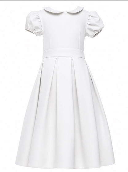 Satin and silk classic flower girl dress for fall-winter weddings and first communions with precise seams, puffed sleeves, Peter Pan collar and a box-pleated skirt.