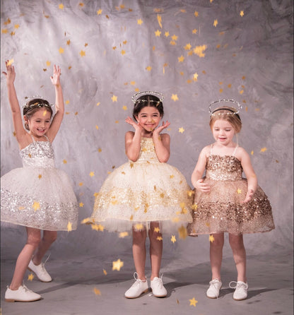 Three sparkly dresses with glittery paillettes and woven metallic threads, featuring a plush petticoat and adjustable grosgrain ribbon straps for birthday celebrations and black tie weddings