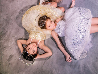Three sparkly dresses with glittery paillettes and woven metallic threads, featuring a plush petticoat and adjustable grosgrain ribbon straps for birthday celebrations and black tie weddings