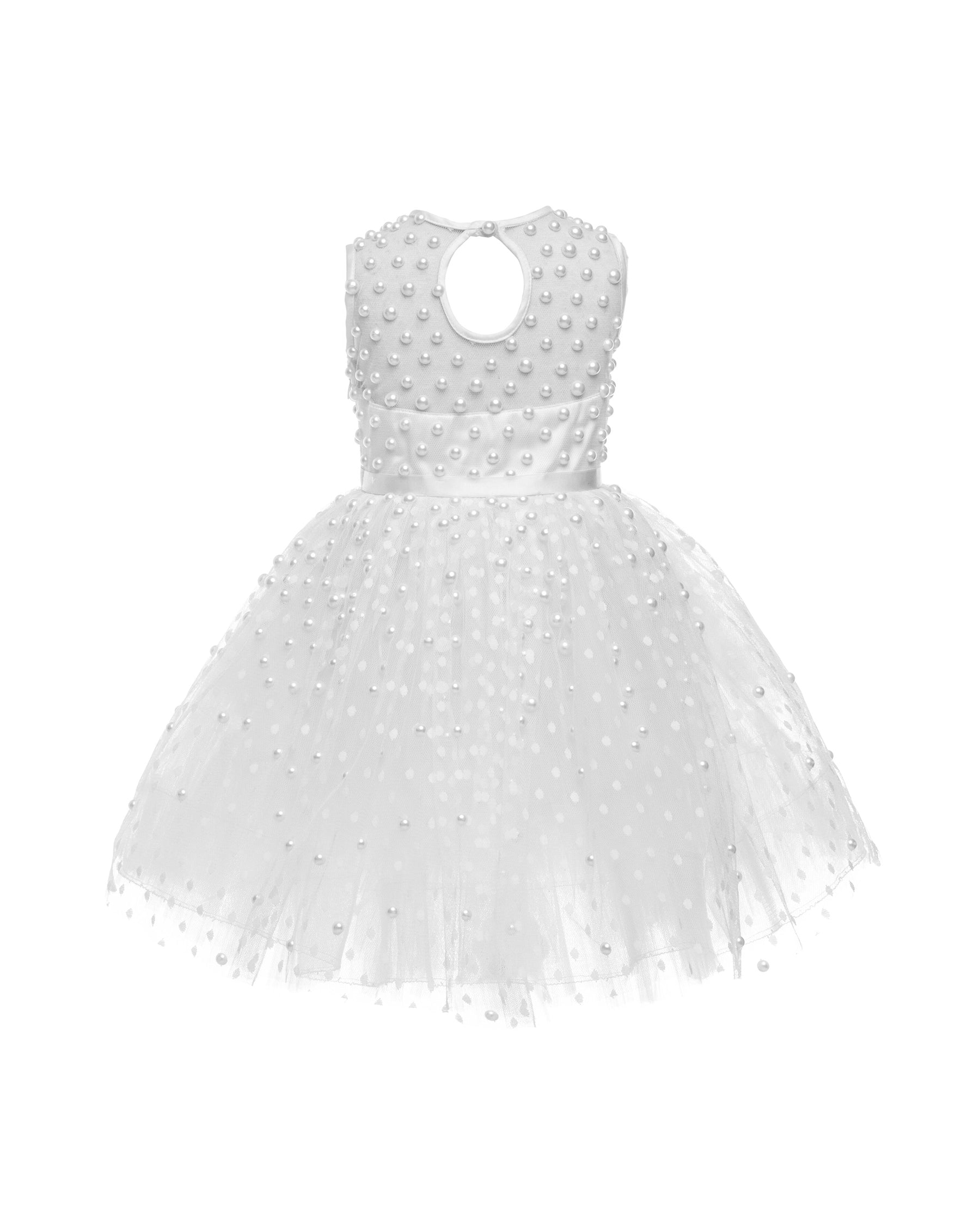 The Pearl flower girl dress featuring intricate pearl embellishments on an illusion neckline and bodice. Swiss dot tulle skirt with a twirly high-low hem, finished with a satin bow. 