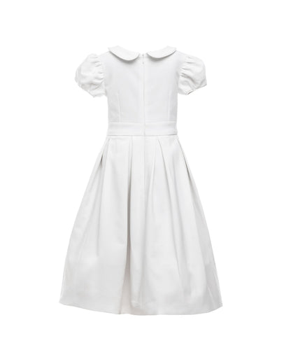 The Rachel – classic flower girl dress with precise seams, puffed sleeves, and a box-pleated skirt. Features a timeless Peter Pan collar, back zip closure, and adjustable petticoat volume. Crafted from satin, silk, and tulle with a silky soft lining, perfect for elegant weddings and special occasions.