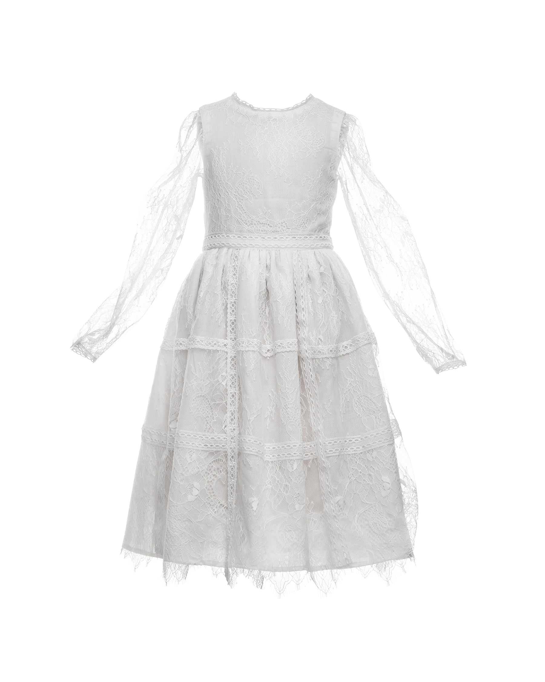 A white, vintage-style dress with sheer sleeves and lace detailing, designed for children, for bohemian and spring-summer weddings