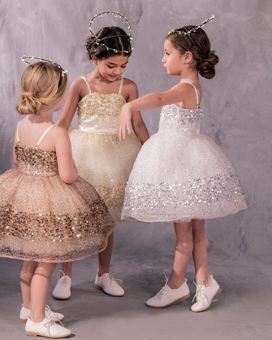 Three sparkly dressed with glittery paillettes and woven metallic threads, featuring a plush petticoat and adjustable grosgrain ribbon straps for birthday celebrations and black tie weddings
