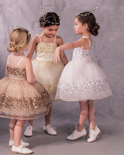Three sparkly dressed with glittery paillettes and woven metallic threads, featuring a plush petticoat and adjustable grosgrain ribbon straps for birthday celebrations and black tie weddings