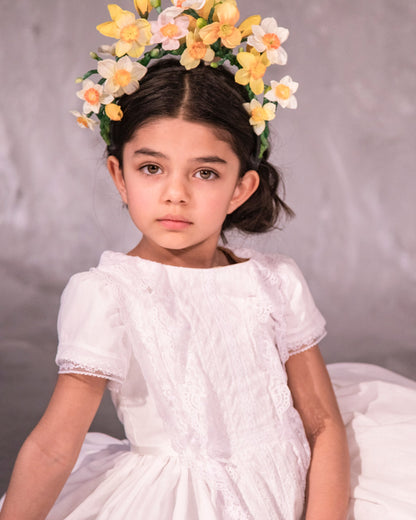 white cotton batiste flower girl dress with lace trims, short sleeves, and a knee-length skirt for summer garden wedding