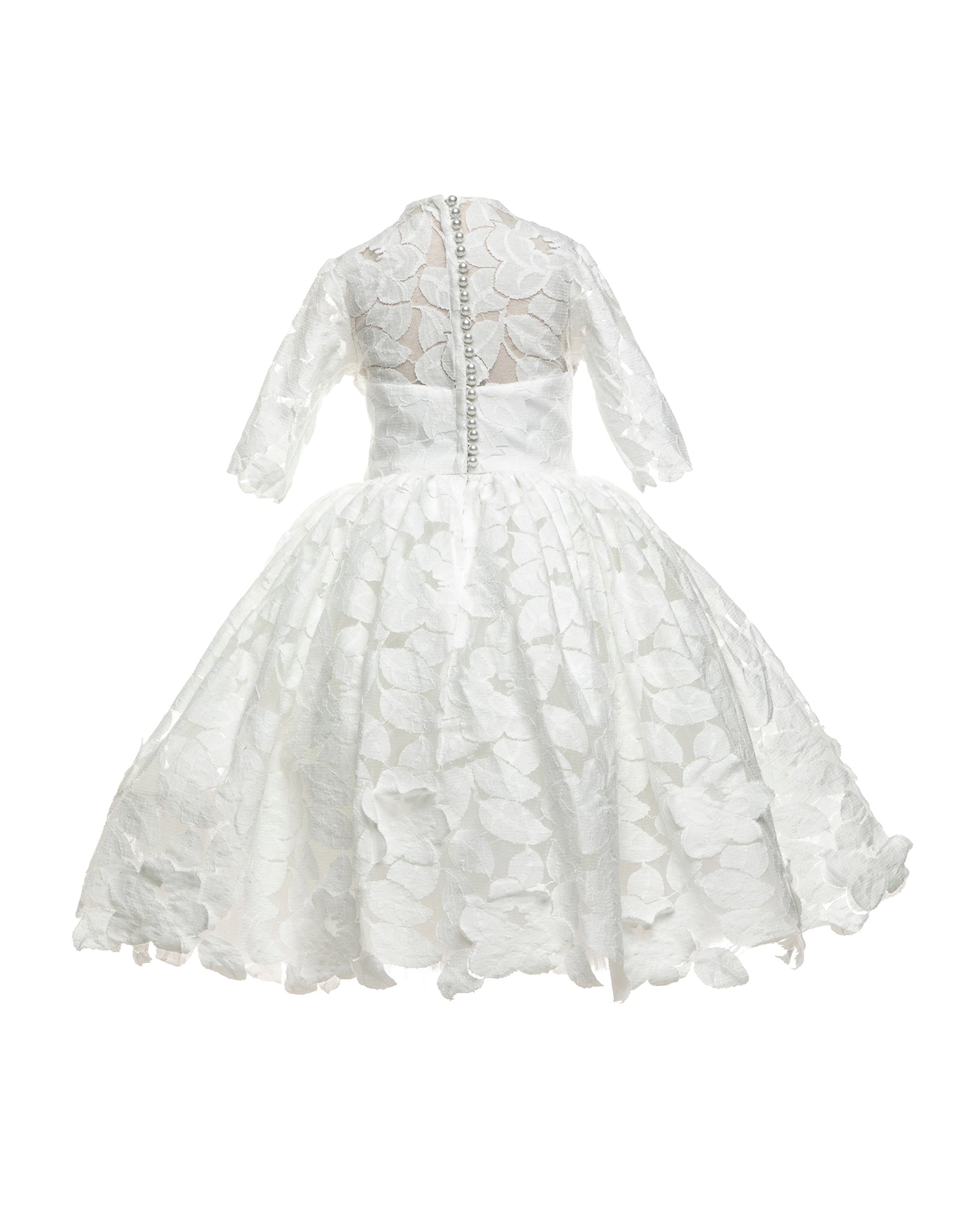 The Isabelle lace flower girl dress with 3/4 long sleeves, tea-length skirt, and pearl button back – ideal for communion and special occasions.