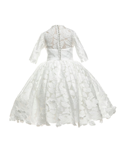 The Isabelle lace flower girl dress with 3/4 long sleeves, tea-length skirt, and pearl button back – ideal for communion and special occasions.