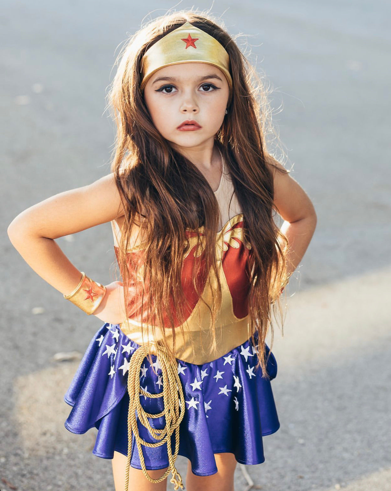 Vintage Wonder Woman costume for kids with red spandex bodice, starry skirt, crown, cuffs, and golden Lasso of Truth – perfect for birthdays, Halloween, and dress-up play.


